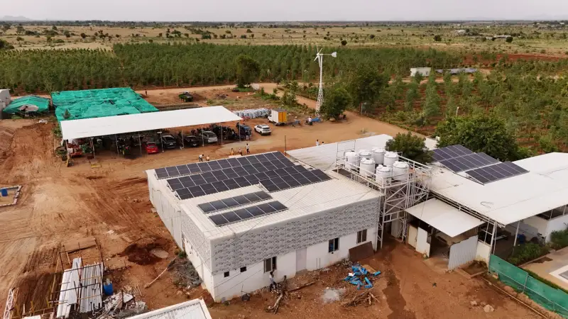 Rooftop solar panels and a wind turbine at GreenX